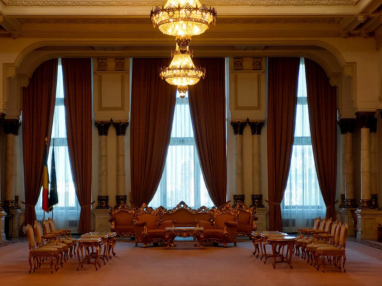 A grand and elegant room with luxurious chandeliers and classic furniture, exuding a regal atmosphere.